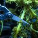 Robotic shears pruning glowing vines, representing mechanical discipline in crypto portfolio rebalancing.
