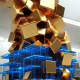 Abstract geometric gold blocks flowing into a financial grid, representing crypto vc trends 2026 and institutional capital allocation.