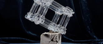 A massive glass sculpture balancing on a cracking stone pedestal, representing the fragility of a low float high fdv crypto token.