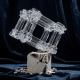 A massive glass sculpture balancing on a cracking stone pedestal, representing the fragility of a low float high fdv crypto token.